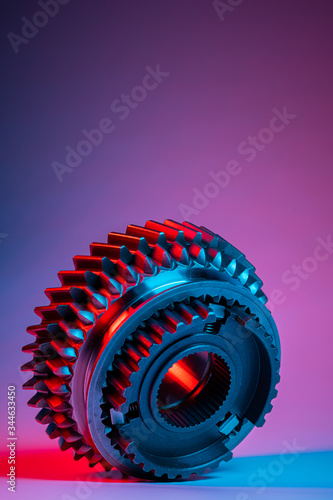 New metal gears spare parts for gearbox in two colors red and blue. Conceptual image of the mechanical elements of the transmission
