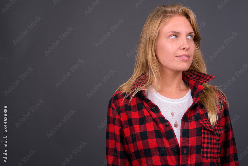 Fototapeta premium Face of young beautiful hipster woman with blond hair thinking