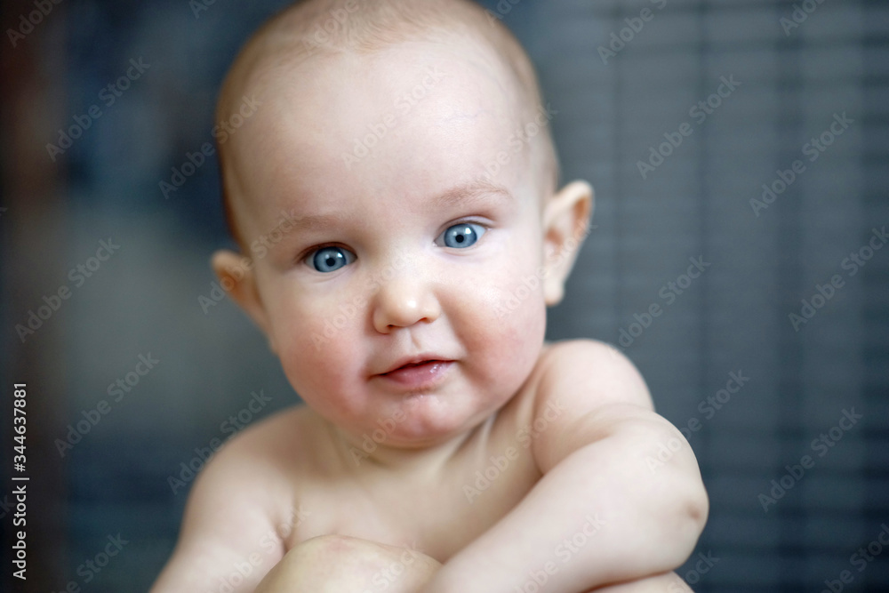 Close cute portrait of lttle cheerful smiling baby. Happy child leaning on mothers. Love, tenderness Close cute portrait of lttle cheerful smiling baby. Happy child leaning on mothers. Love, tenderness