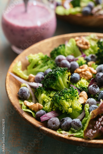 Home made vegan broccoli and blueberry salad with toasted walnuts, served with a blueberry dressing