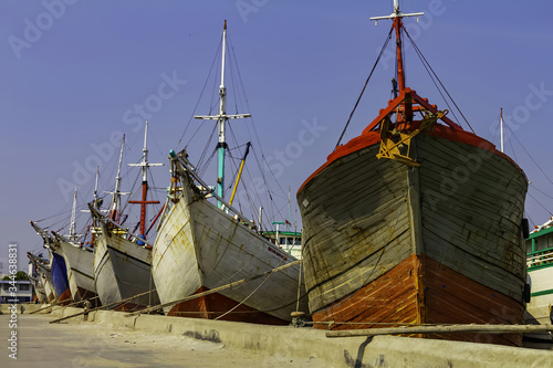 Fishing boats in Sunda Kelapa Port. Jakarta city, Java Island, Indonesia - 10/02/20 photo