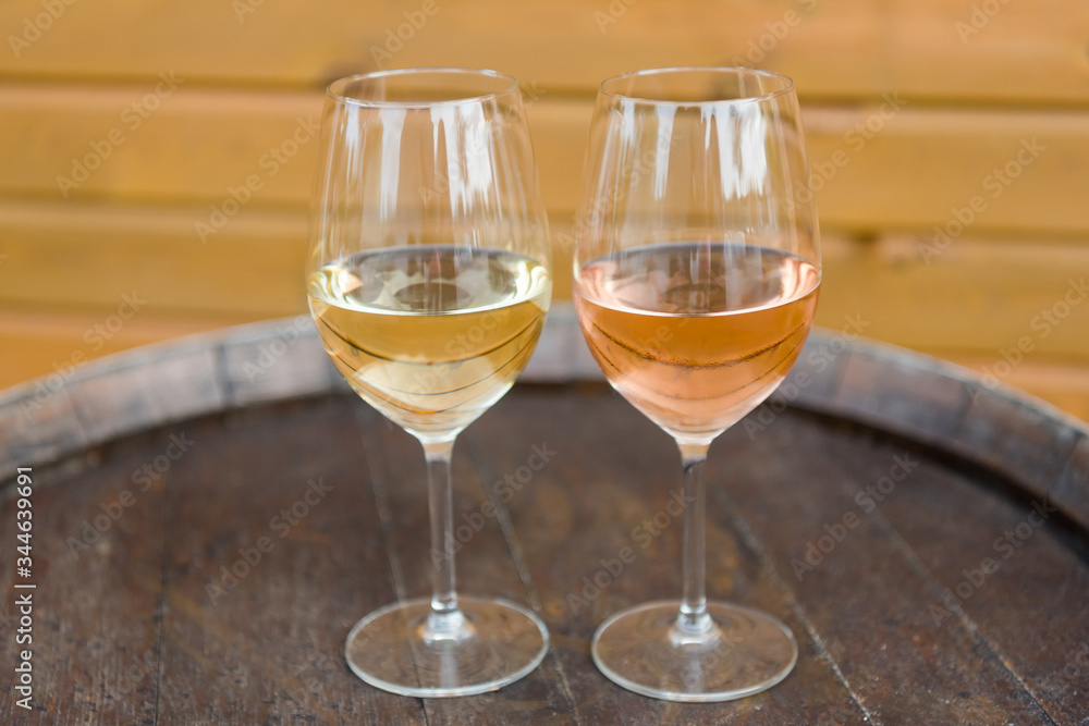 Wine glasses with white and rose wines on the cork table Wine glasses with white and rose wines on the cork table