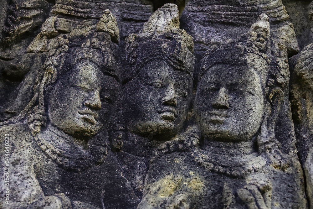 High relief carved in stone. heads of three nobles. Borobudur temple located at Magelang, Central Java, Indonesia