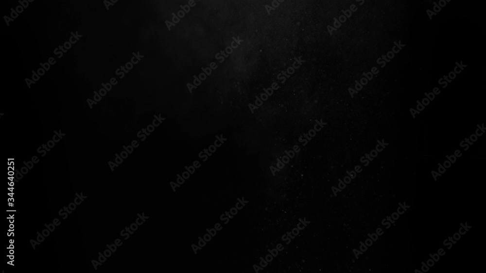 A dusty bullet hits a wall with flying debris. Powder explosion on a black background. Exposure to dust particles. Dust explosion on a black background, slow motion close-up. A dusty bullet hits a wall with flying debris. Powder explosion on a black background. Exposure to dust particles. Dust explosion on a black background, slow motion close-up.