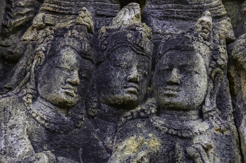 High relief carved in stone. heads of three nobles. Borobudur temple located at Magelang, Central Java, Indonesia