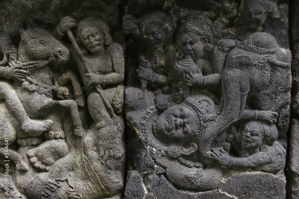 Battle between giants and demons sculped in the corridor wall of Prambanan Hindu Temple near Yogyakarta, Java island, Indonesia