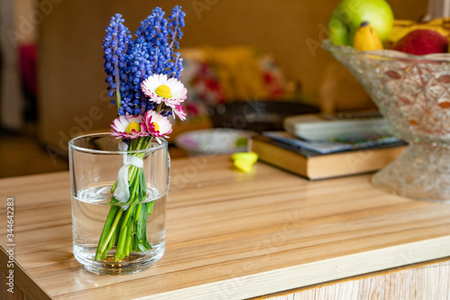 a small bouquet of blue flowers is on the table