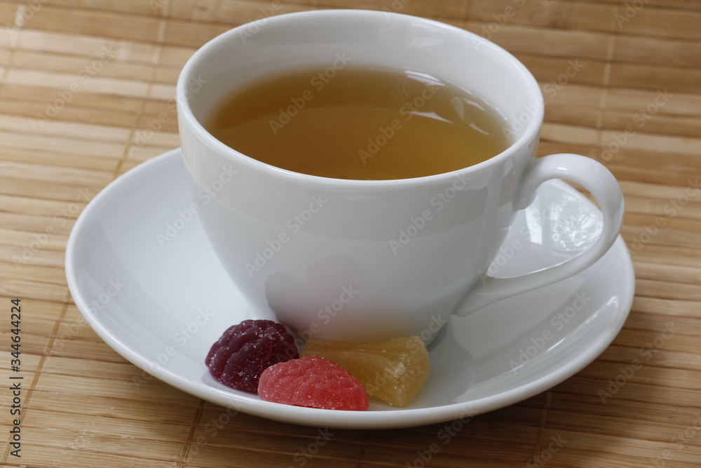 A Cup of tea and slices of marmalade on a saucer A Cup of tea and slices of marmalade on a saucer