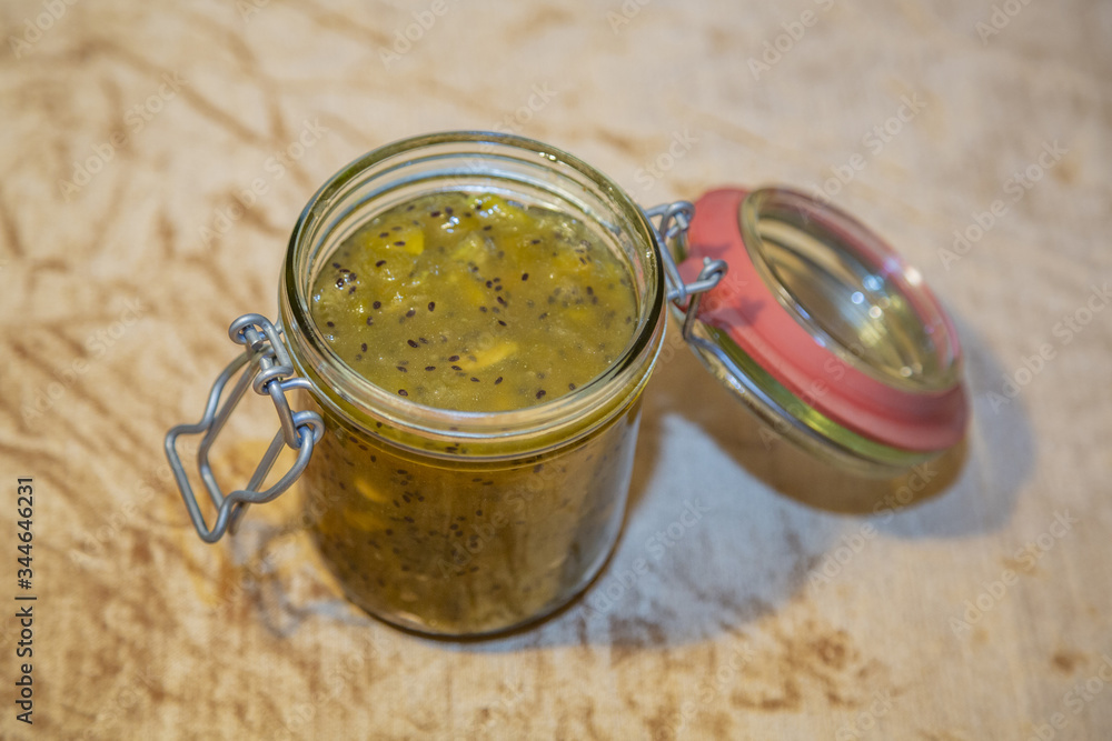 Appetizing homemade sweet sugar jam with slices of fresh green kiwi Appetizing homemade sweet sugar jam with slices of fresh green kiwi
