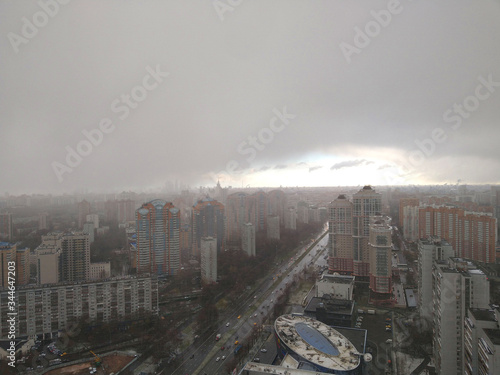 Wallpaper Mural Aerial photo of a big city with multi-storey residential buildings from a height in cloudy weather with snowfall, dark clouds and a distant horizon Torontodigital.ca