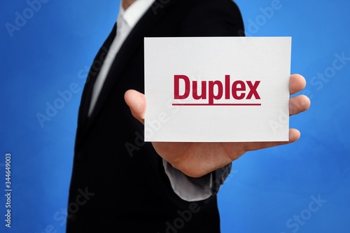 Duplex. Lawyer in a suit holds card at the camera. The term Duplex is in the sign. Concept for law, justice, judgement