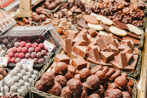A selection of various delicious chocolate deserts for sale at a market stall