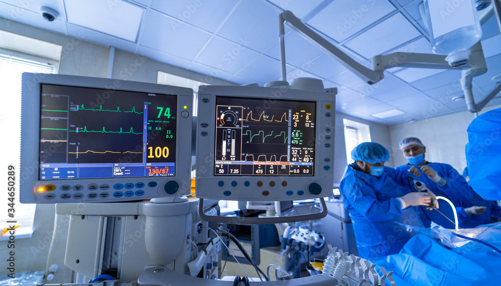 Two screens in operating room. Medical devices, interior hospital design concept. Interior of operating room in modern clinic, monitor with tests closeup Two screens in operating room. Medical devices, interior hospital design concept. Interior of operating room in modern clinic, monitor with tests closeup