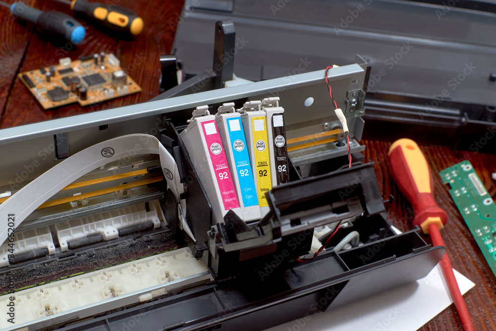 The printer is disassembled. Repair of the printer. Color ink