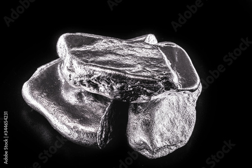 Fotografie Rhodium nugget, chemical element with Rh symbol, metal for industrial use, used in jewelry and automatic equipment