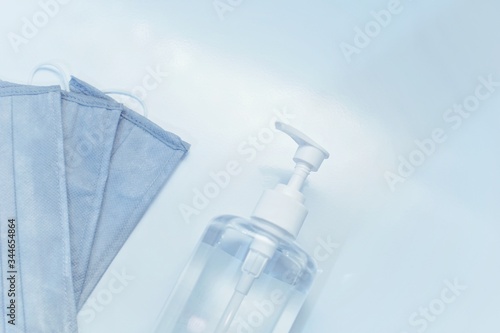 medical mask and hand sanitizer bottle with white background