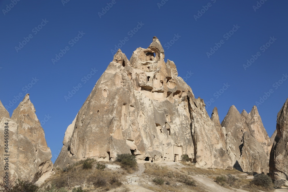 Rock formations and cave city  in Cappadocia Turkey. Tuff volcanic cliffs and sandstone hills landscape.