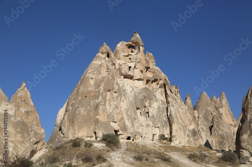 Rock formations and cave city in Cappadocia Turkey. Tuff volcanic cliffs and sandstone hills landscape.