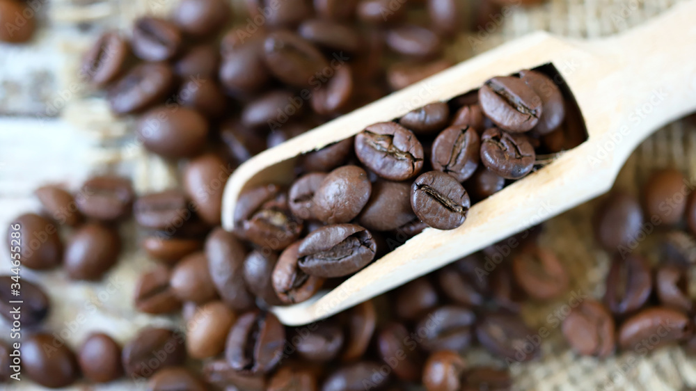 Fototapeta premium Selective focus. Macro. Grains of coffee in a wooden spatula.