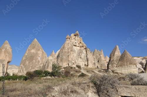 Rock formations and cave city in Cappadocia Turkey. Tuff volcanic cliffs and sandstone hills landscape.