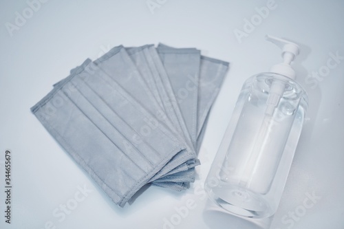 medical mask and hand sanitizer bottle with white background © rifky