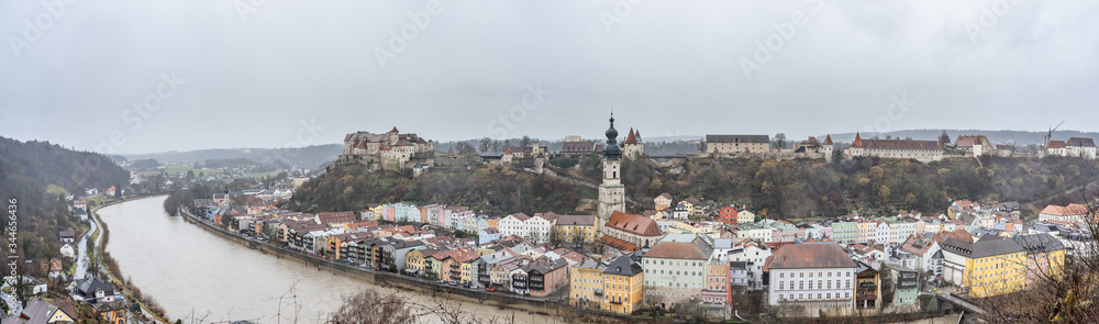 Panoramic view of Burg zu Burghausen, world's longest castle complex on hill along river during rainy days in Burghausen, Germany
