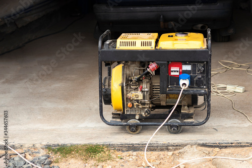 stand-alone diesel generator to supply electricity in an emergency. Yellow color. Serves not a large residential building