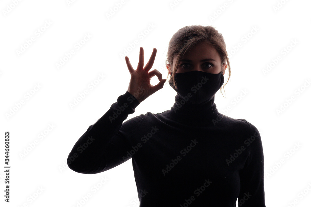 figure young woman in black mask showing gesture ok, lifestyle 2020 under quarantine and epidemic, concept of security figure young woman in black mask showing gesture ok, lifestyle 2020 under quarantine and epidemic, concept of security