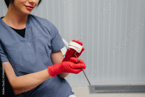 The doctor shows a cast of the patient's jaw photo