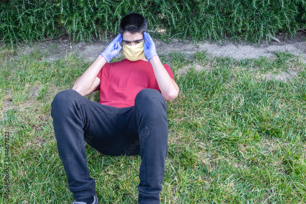 Teenager does exercise with mask and gloves during a pandemic. COVID-19. Health care. Teenager does exercise with mask and gloves during a pandemic. COVID-19. Health care.