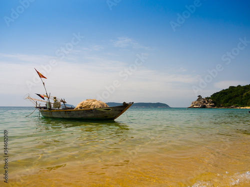 Beautiful view of a boat in the water in a sunny day, in Vietnam. Hoian is recognized as a World Heritage Site by UNESCO photo
