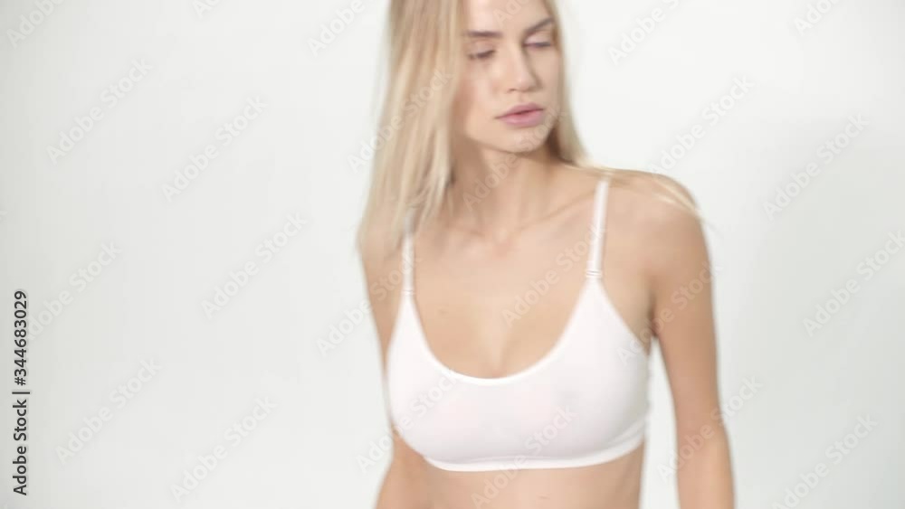 Realtime motion girl posing in perfect white studio in nice shorts and sexy style with wind Realtime motion girl posing in perfect white studio in nice shorts and sexy style with wind