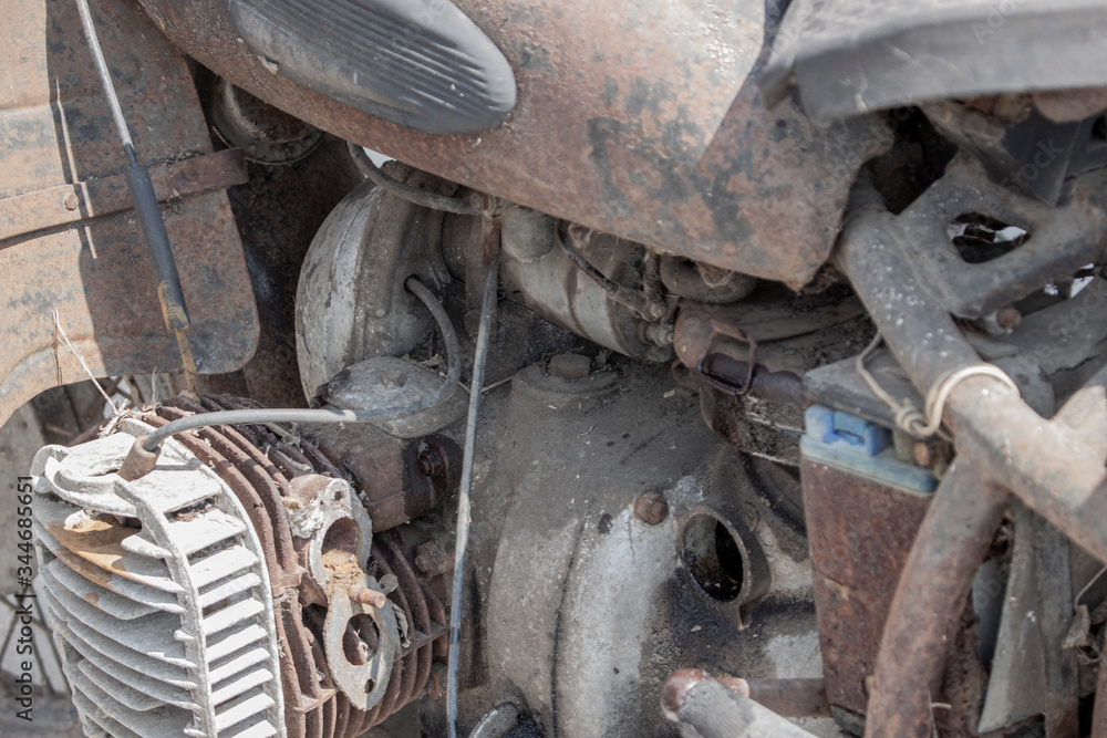 Old antique bike covered with rust. Engine retro moto, dirt and plaque. Old antique bike covered with rust. Engine retro moto, dirt and plaque.