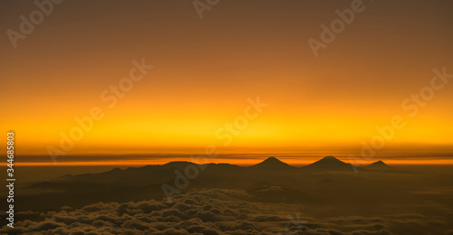 Unbelievable golden sunrise views to Dieng  Sumbing   Sindoro and Merbabu volcanoes seen from Slamet volcano