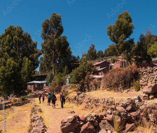 group of people walk in the  Island Amantany Perú photo