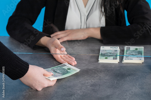 Wallpaper Mural A bank teller accepts money from a client who transfers the cash to be paid into a bank account. Torontodigital.ca