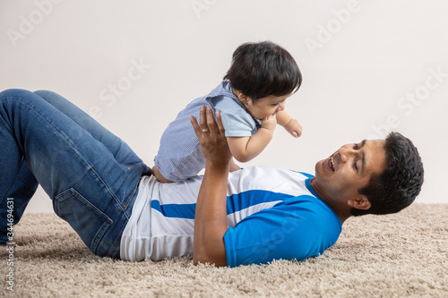dad playing on the floor with his son on father's day