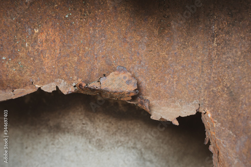 Texture of old rusty metal with torn edges and a hole