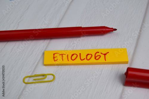 Etiology write on sticky notes isolated on office desk