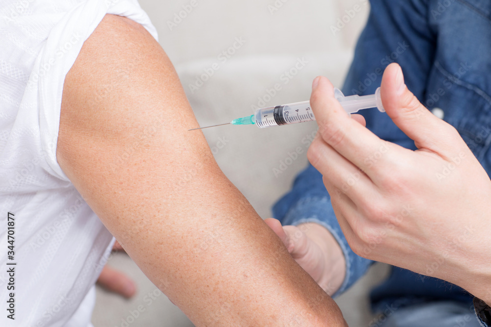 Person gets a vaccine in times of coronavirus Person gets a vaccine in times of coronavirus