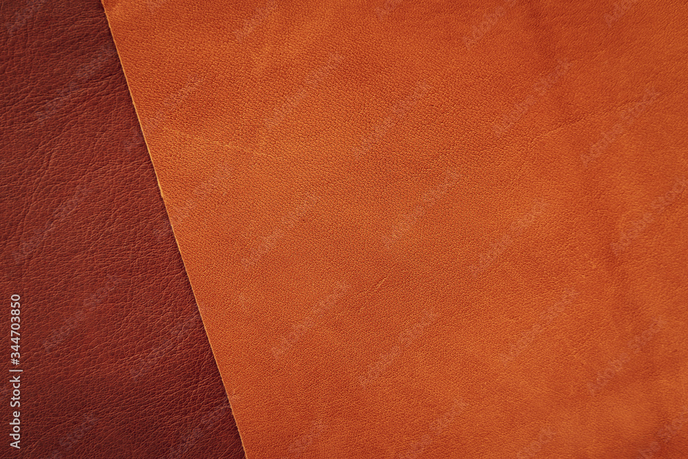 Fototapeta premium Brown and tan leather samples close-up, abstract background, texture. Shopping and industry concept