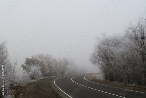 Road on a winter frosty foggy day