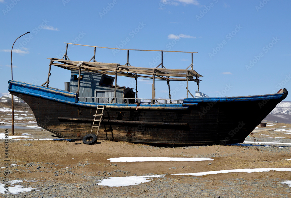 Abandoned North Korean fishing schooner on the shore of the Sea of ​​Japan, Primorye, Russia.