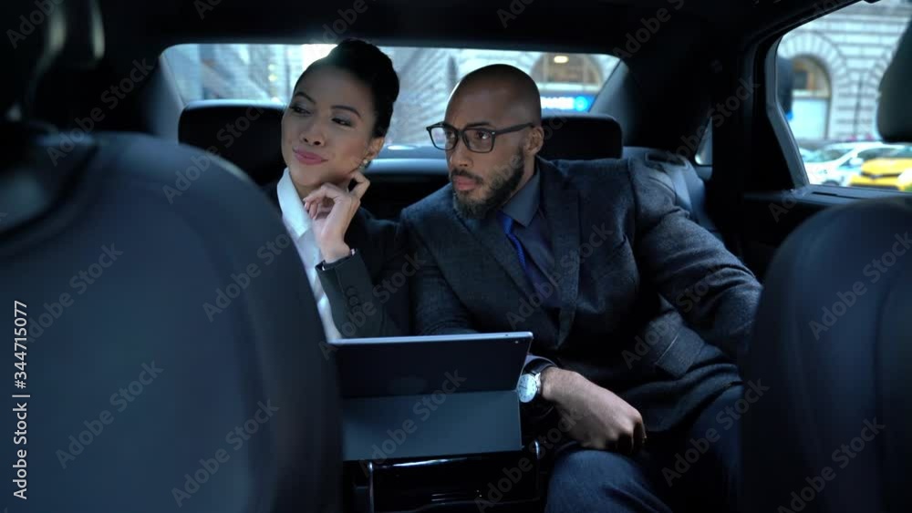 Male Chinese woman using cellphone device for clicking selfie pictures during car transportation with African American colleague, multiracial partners posing for front smartphone picture
Male Chinese woman using cellphone device for clicking selfie pictures during car transportation with African American colleague, multiracial partners posing for front smartphone picture