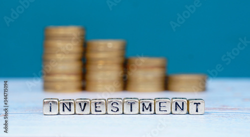 Wallpaper Mural word INVESTMENT and coins on wooden background. Funding and business concept. Torontodigital.ca