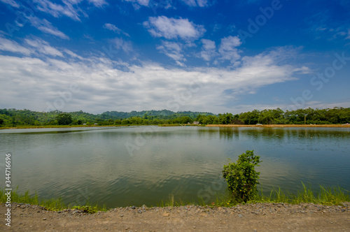 Lake in in the coast of Same, surrounded with abundat vegetation in a sunny day in the Ecuadorian coasts