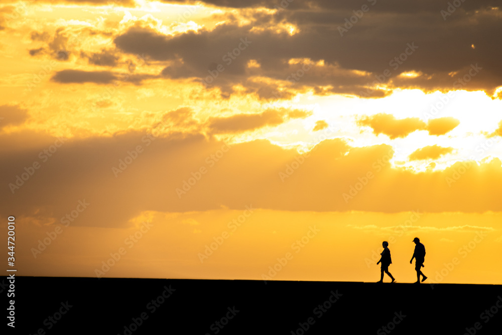 silhouette of a woman on a sunset background