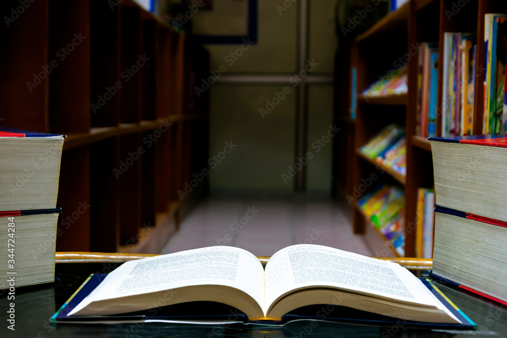 Fototapeta premium The open book was placed on a table in the library