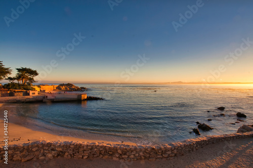 Relaxing view of Pacific Grove Beach and pier at sunset.