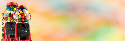 Foto Coin Operated Gumball Machines isolated on colorful background